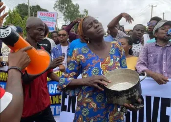 Protest: Woman joins protest with an empty pot shouting ‘hunger..hunger’ in Lagos