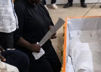 Vengeance: Mother Places Cutlass in Son’s Coffin During Funeral in Jos